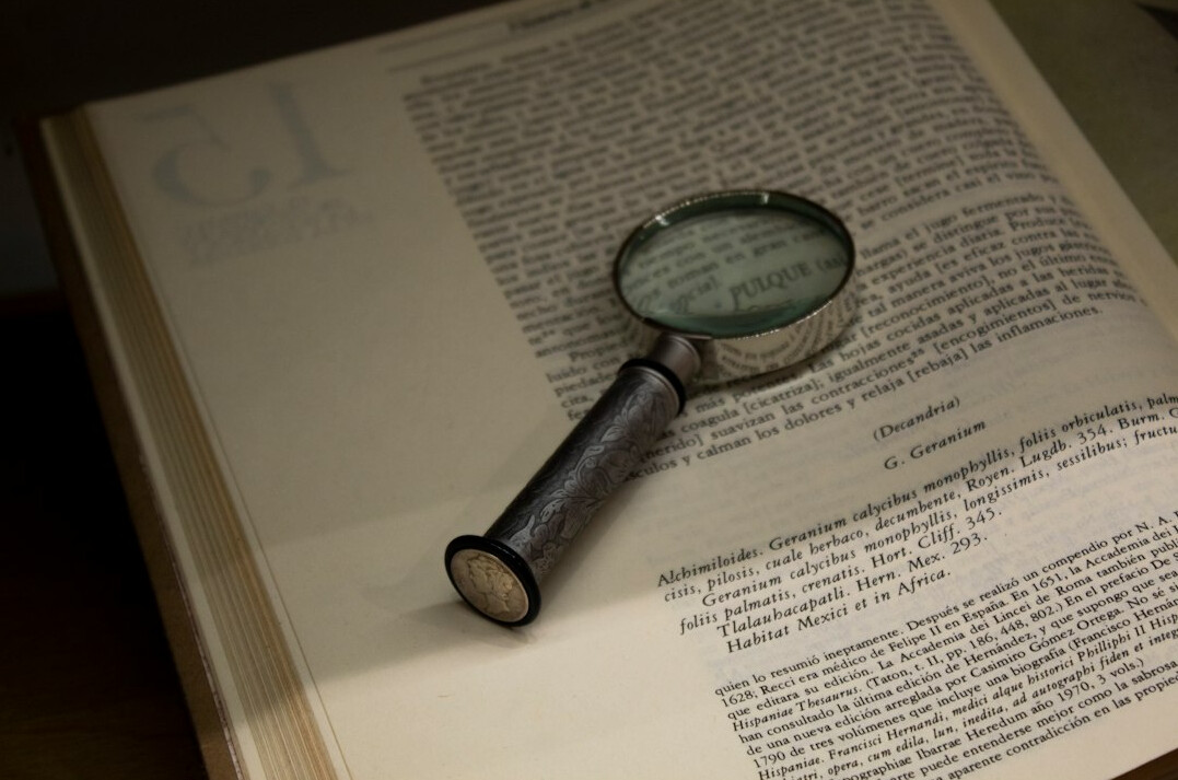 book pages with magnifying glass