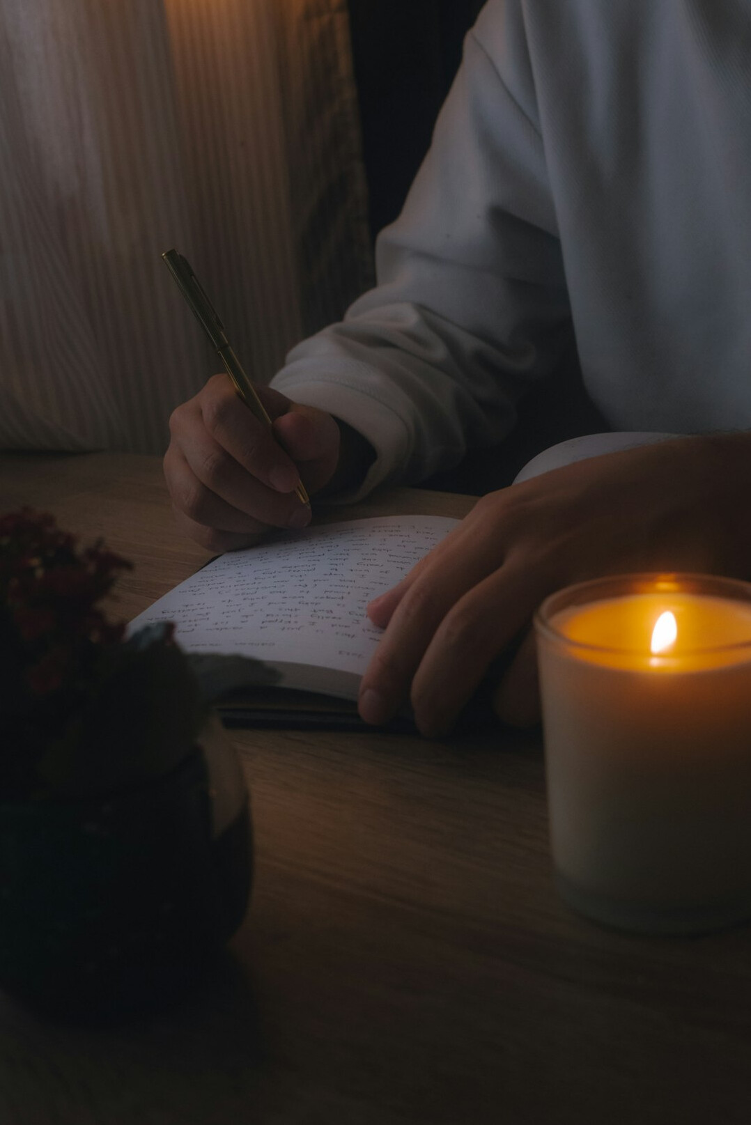 person writing notes in journal